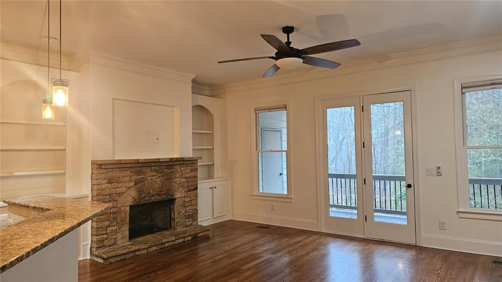 3533 Peacock Road Alpharetta, GA 30004 - Photo 13 of 21 a living room with a fireplace cabinet and a wooden floor