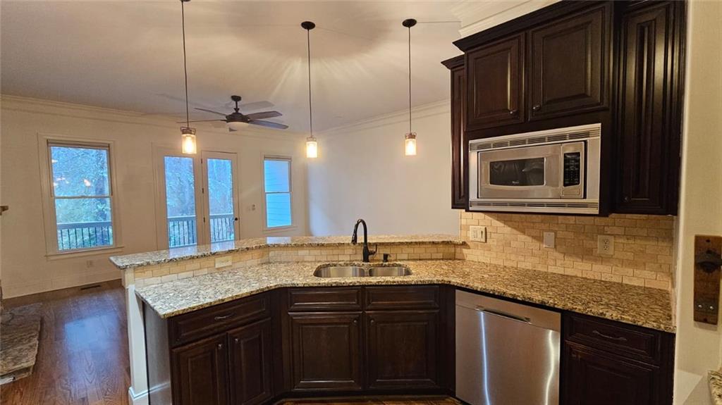 3533 Peacock Road Alpharetta, GA 30004 - Photo 3 of 21 a kitchen with granite countertop a sink cabinets and stainless steel appliances