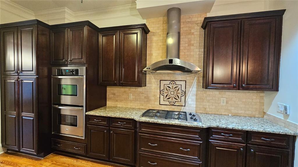 3533 Peacock Road Alpharetta, GA 30004 - Photo 4 of 21 a kitchen with stainless steel appliances granite countertop wooden cabinets and a refrigerator