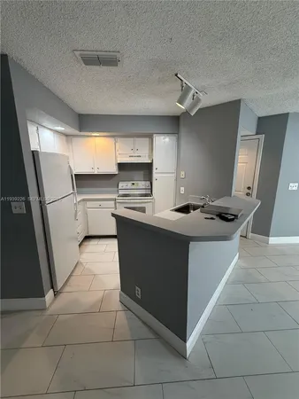 a kitchen with a cabinets and appliances