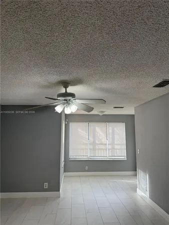 a view of a livingroom with a chandelier fan