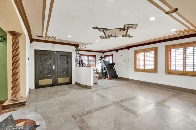 a view of a patio with plants and chairs under an umbrella