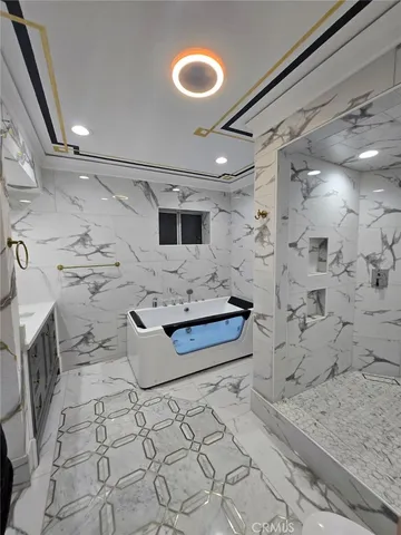 a living room with a bed furniture and a flat screen tv