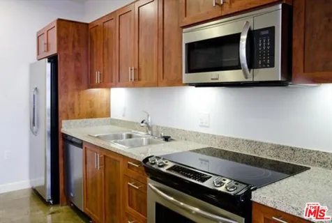 a kitchen with granite countertop a stove and a microwave