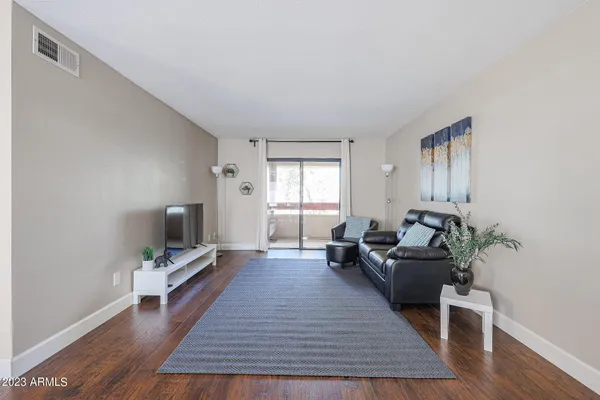 a living room with furniture window and wooden floor