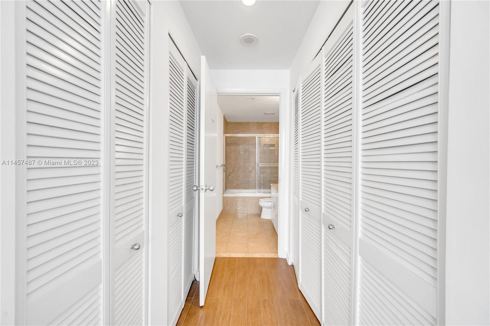 801 Brickell Key Boulevard, Unit 2208 Miami, FL 33131 - Photo 11 of 22 a view of a bathroom with sink and wooden floor