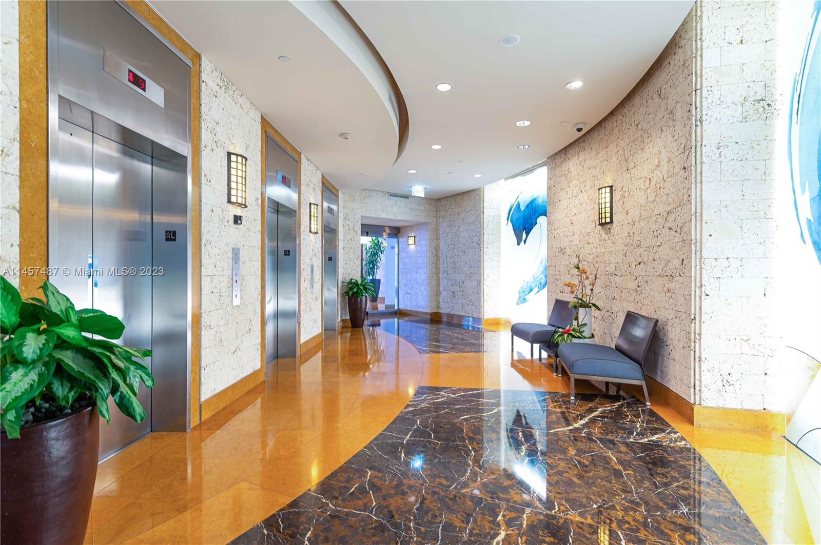 801 Brickell Key Boulevard, Unit 2208 Miami, FL 33131 - Photo 22 of 22 a lobby with furniture and a potted plant