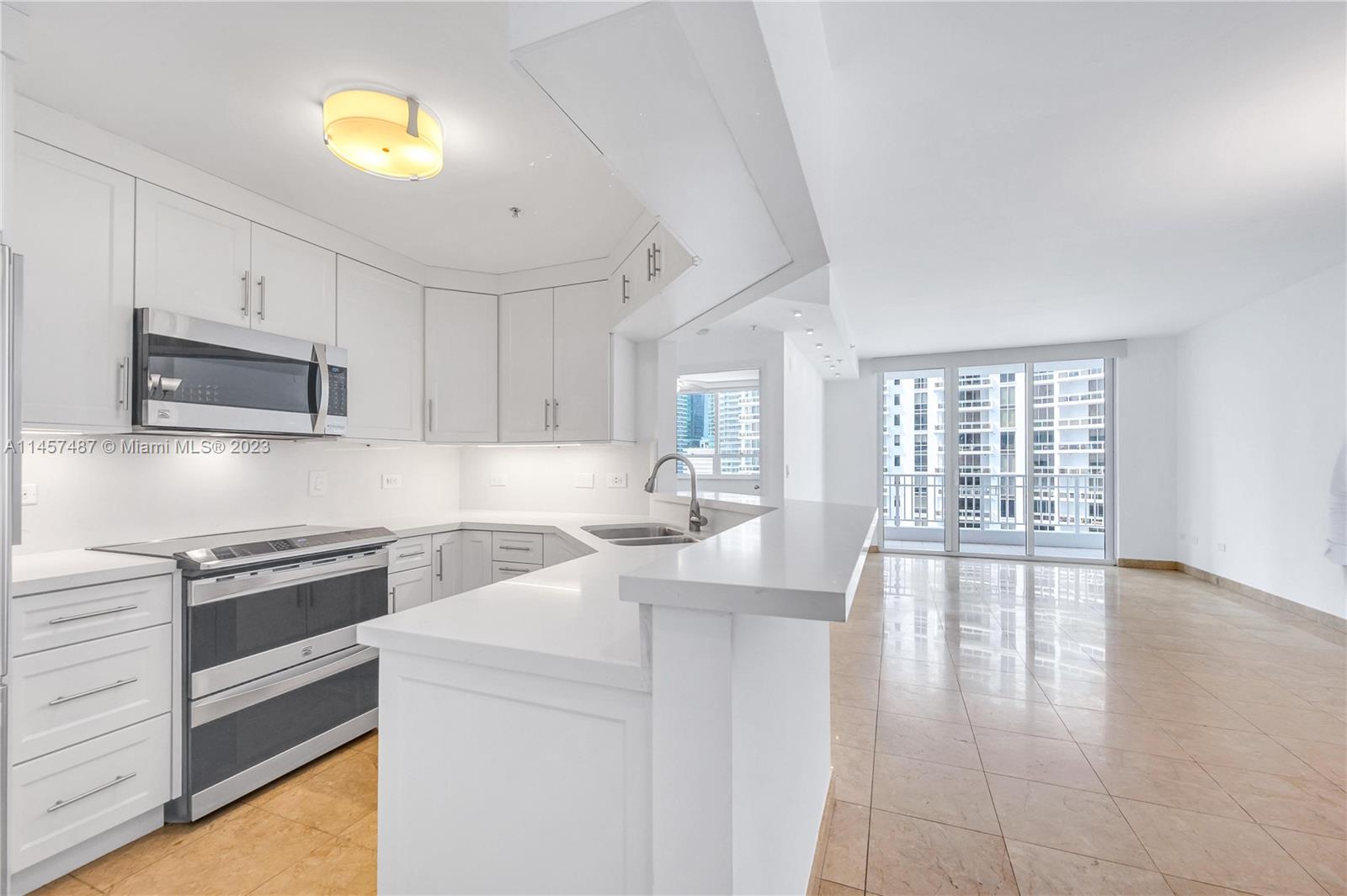 801 Brickell Key Boulevard, Unit 2208 Miami, FL 33131 - Photo 4 of 22 a kitchen with a sink appliances and cabinets