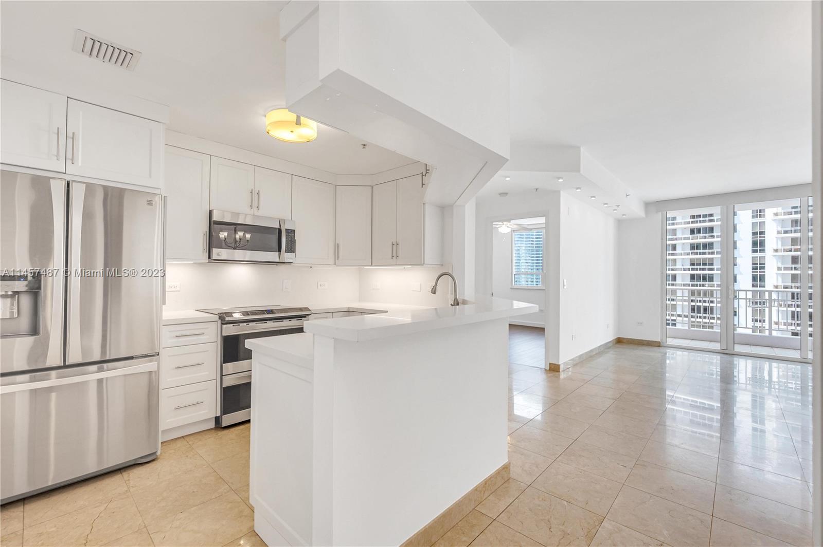 801 Brickell Key Boulevard, Unit 2208 Miami, FL 33131 - Photo 5 of 22 a kitchen with stainless steel appliances a refrigerator stove and sink