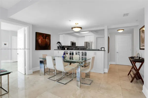 a view of a dining room with furniture and a chandelier