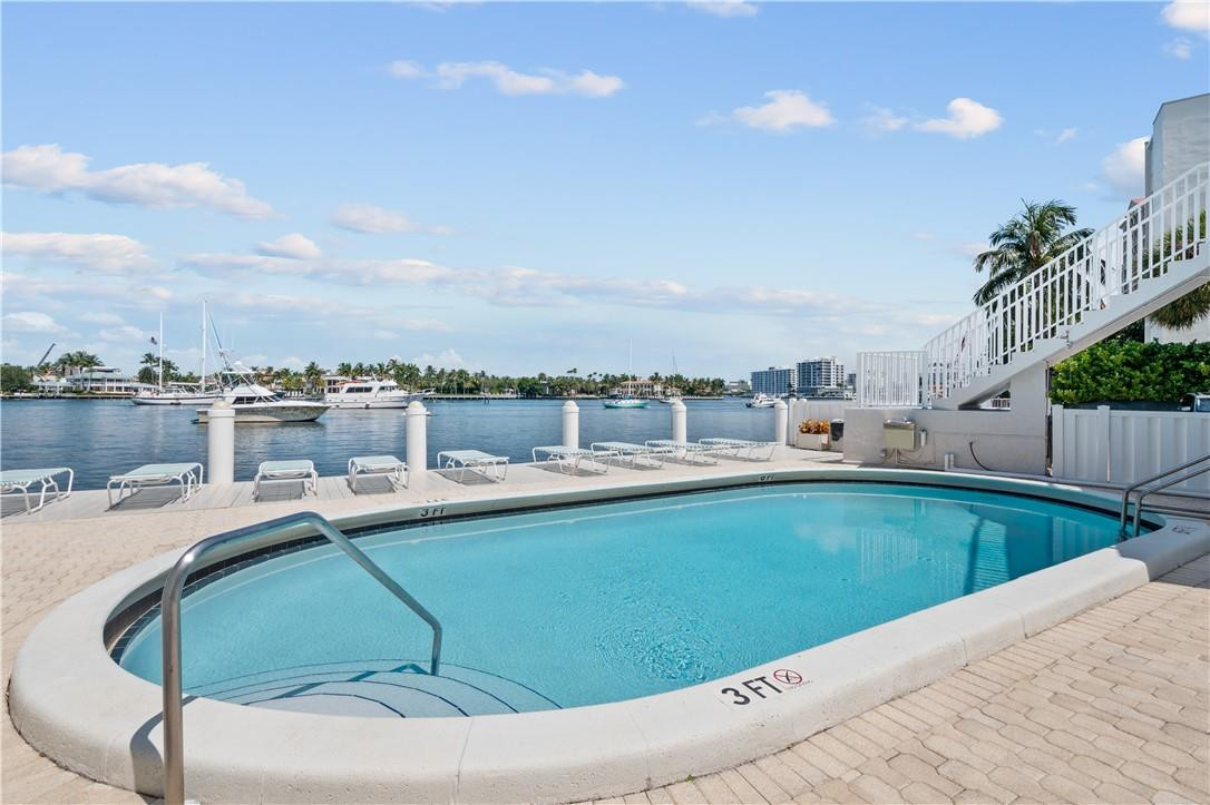 95 North Birch Road, Unit 405 Fort Lauderdale, FL 33304 - Photo 4 of 34 a view of a swimming pool and a chairs