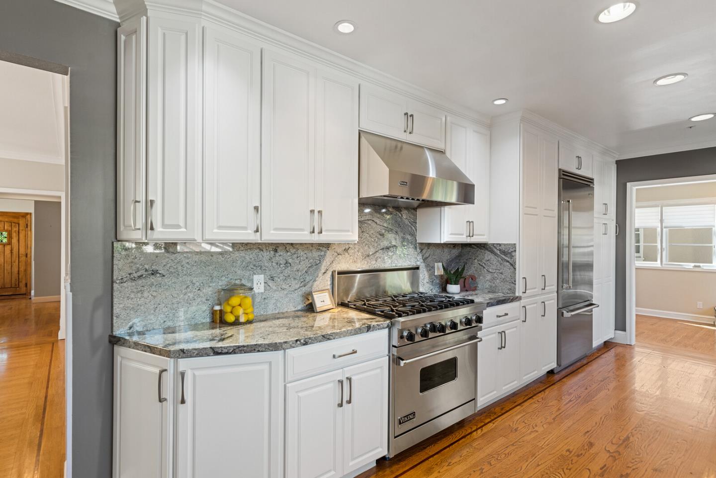 1416 Columbus Avenue Burlingame, CA 94010 - Photo 14 of 39 a kitchen with stainless steel appliances granite countertop a stove a sink and a refrigerator with wooden floors