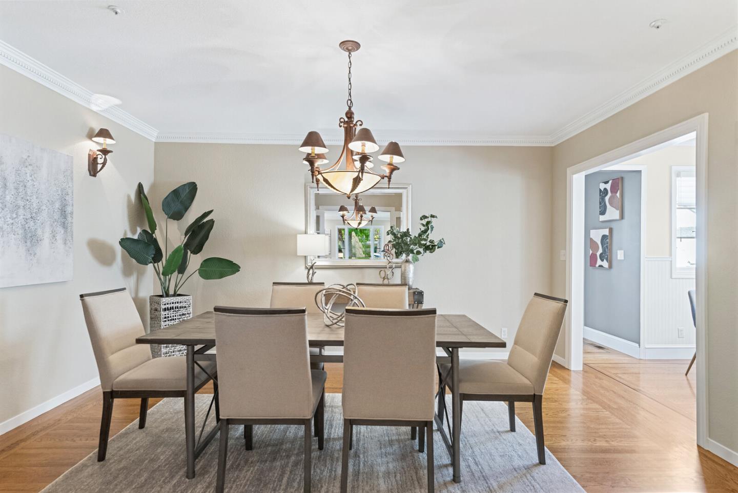 1416 Columbus Avenue Burlingame, CA 94010 - Photo 17 of 39 a dining room with furniture potted plants and wooden floor