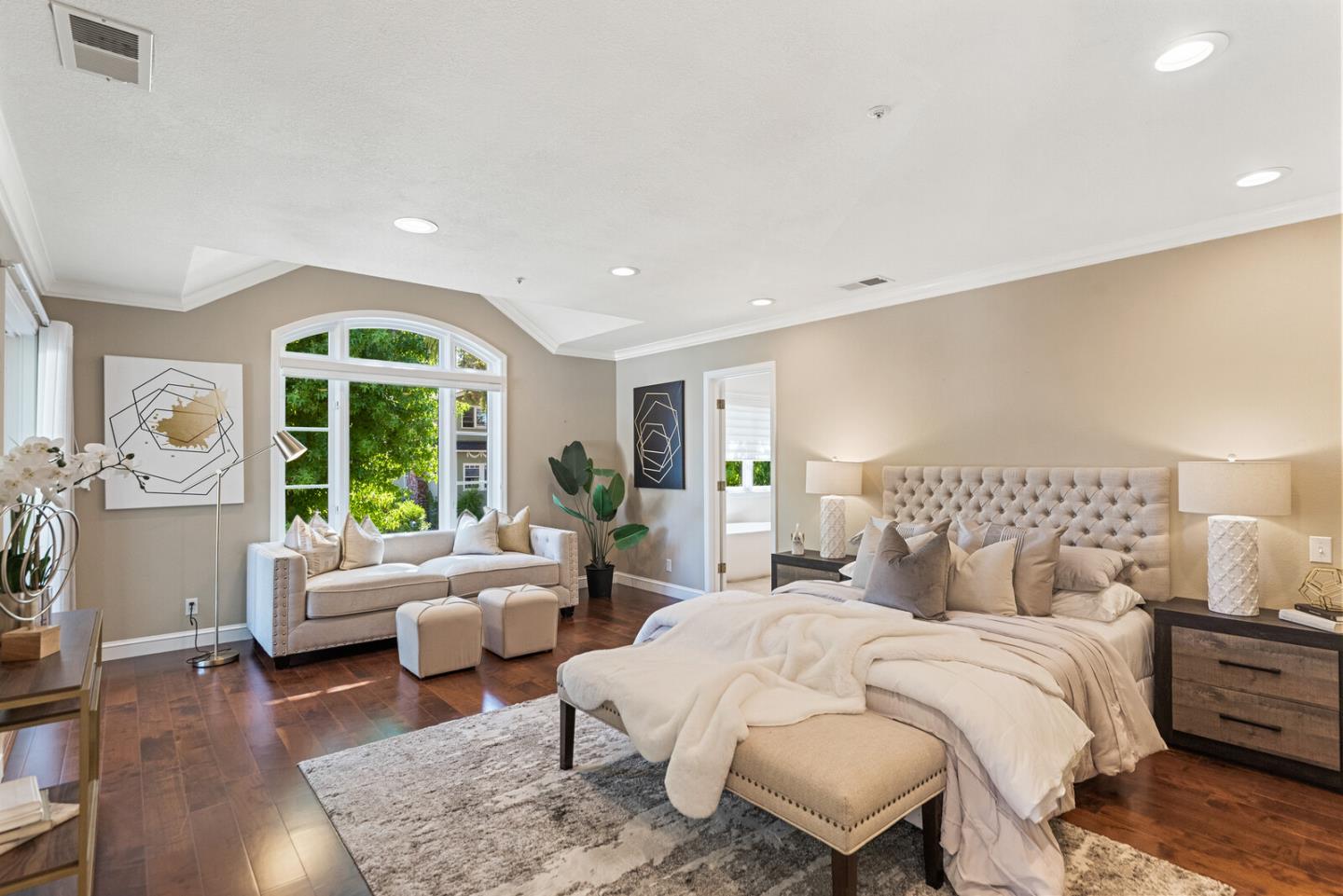 1416 Columbus Avenue Burlingame, CA 94010 - Photo 24 of 39 a bedroom with a bed a couch and a large window with wooden floor