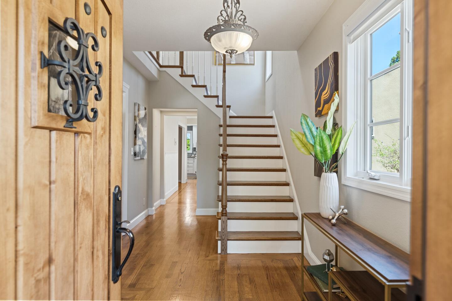 1416 Columbus Avenue Burlingame, CA 94010 - Photo 4 of 39 a view of a hallway with wooden floor and windows