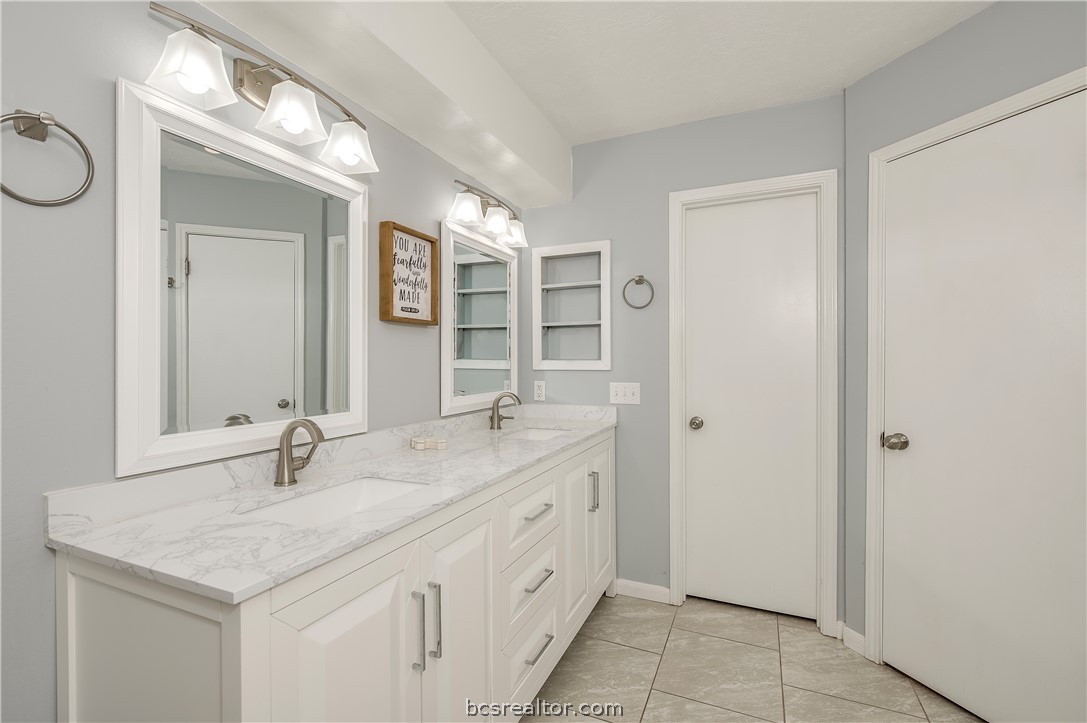 2009 Cobblestone Lane Bryan, TX 77807 - Photo 13 of 23 a bathroom with a sink and a mirror