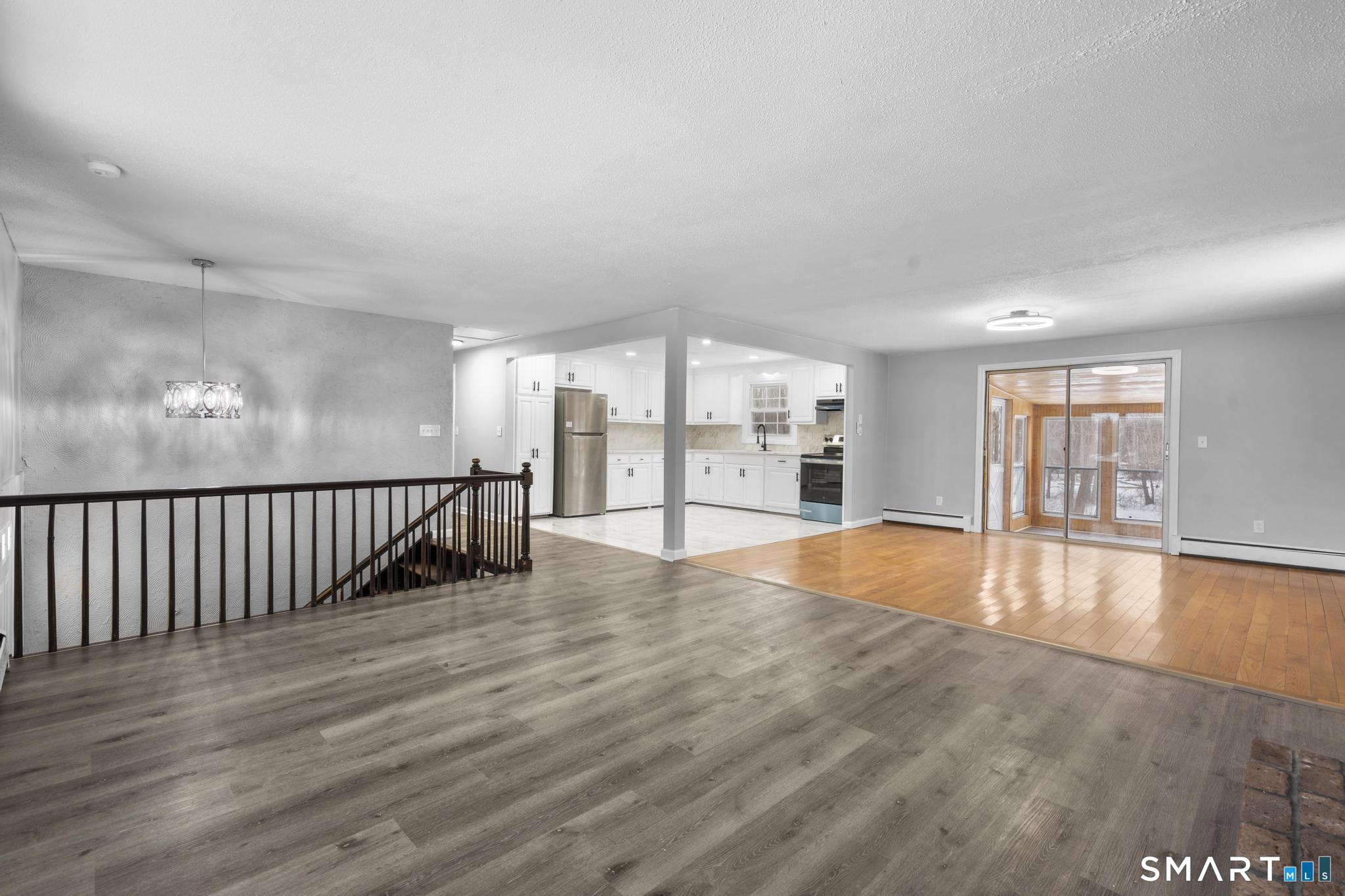 133 Phelps Road East Windsor, CT 06088 - Photo 12 of 40 an empty room with wooden floor and windows