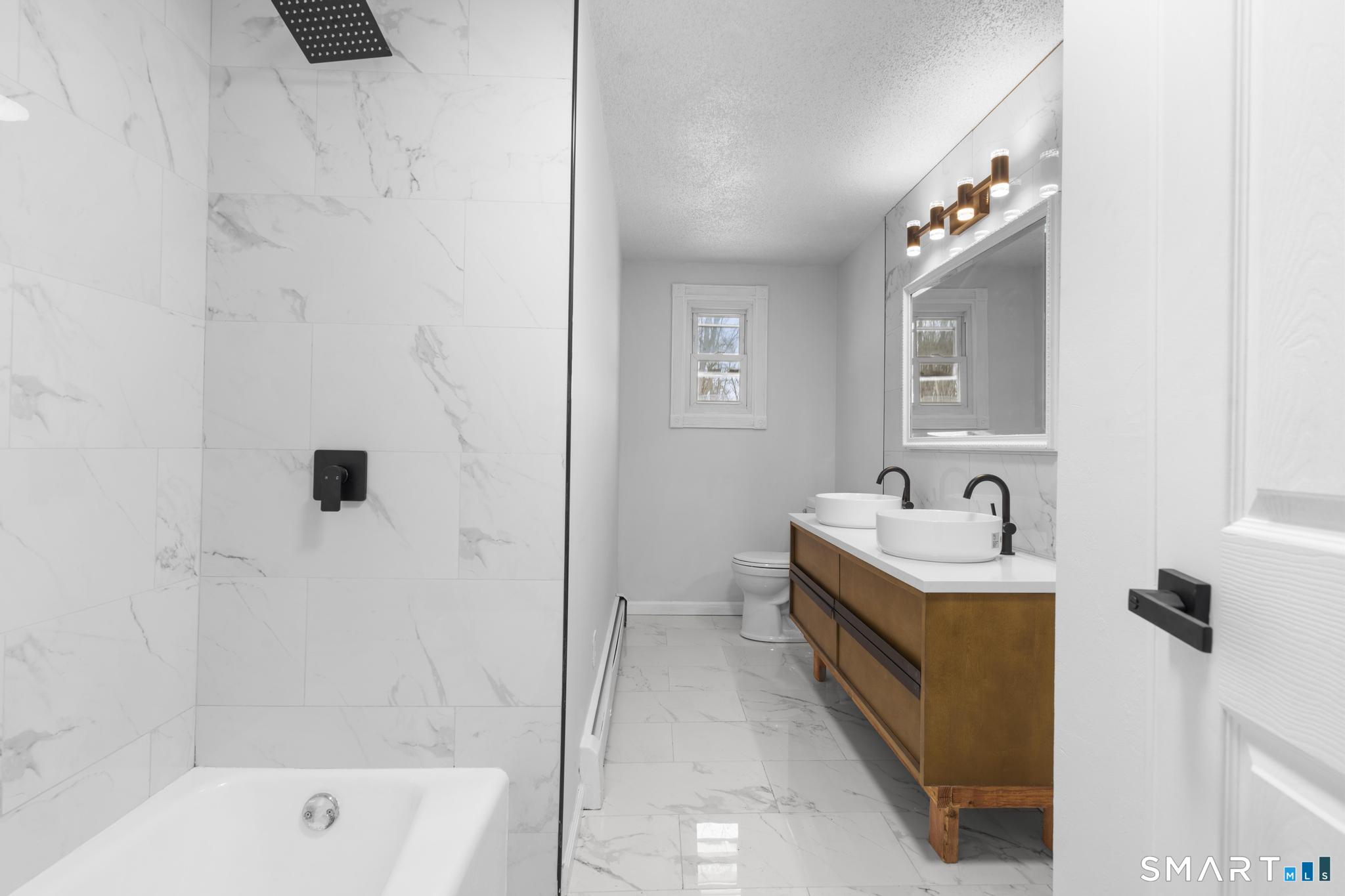 133 Phelps Road East Windsor, CT 06088 - Photo 16 of 40 a bathroom with a granite countertop sink mirror and bathtub