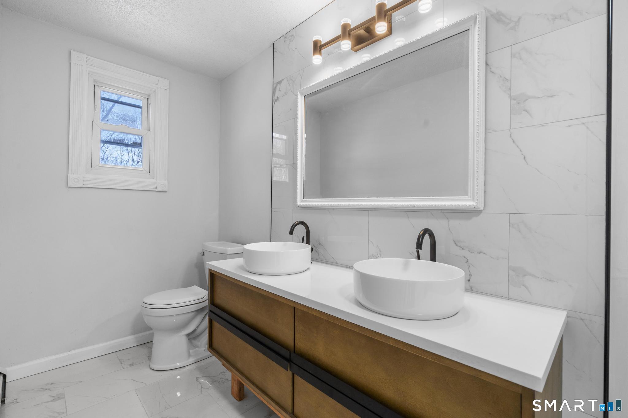 133 Phelps Road East Windsor, CT 06088 - Photo 17 of 40 a bathroom with a sink and a toilet