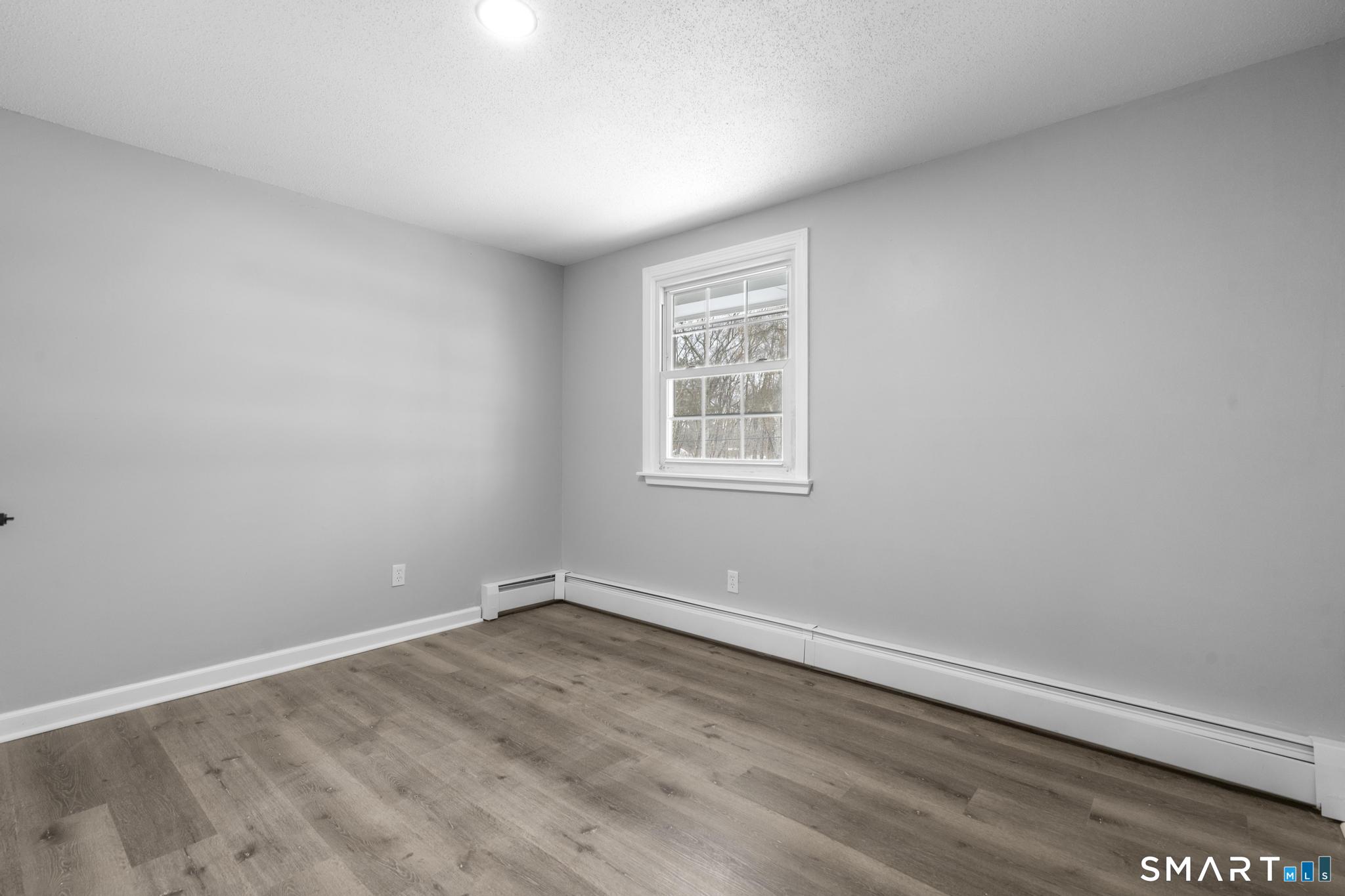 133 Phelps Road East Windsor, CT 06088 - Photo 20 of 40 wooden floor in an empty room with a window