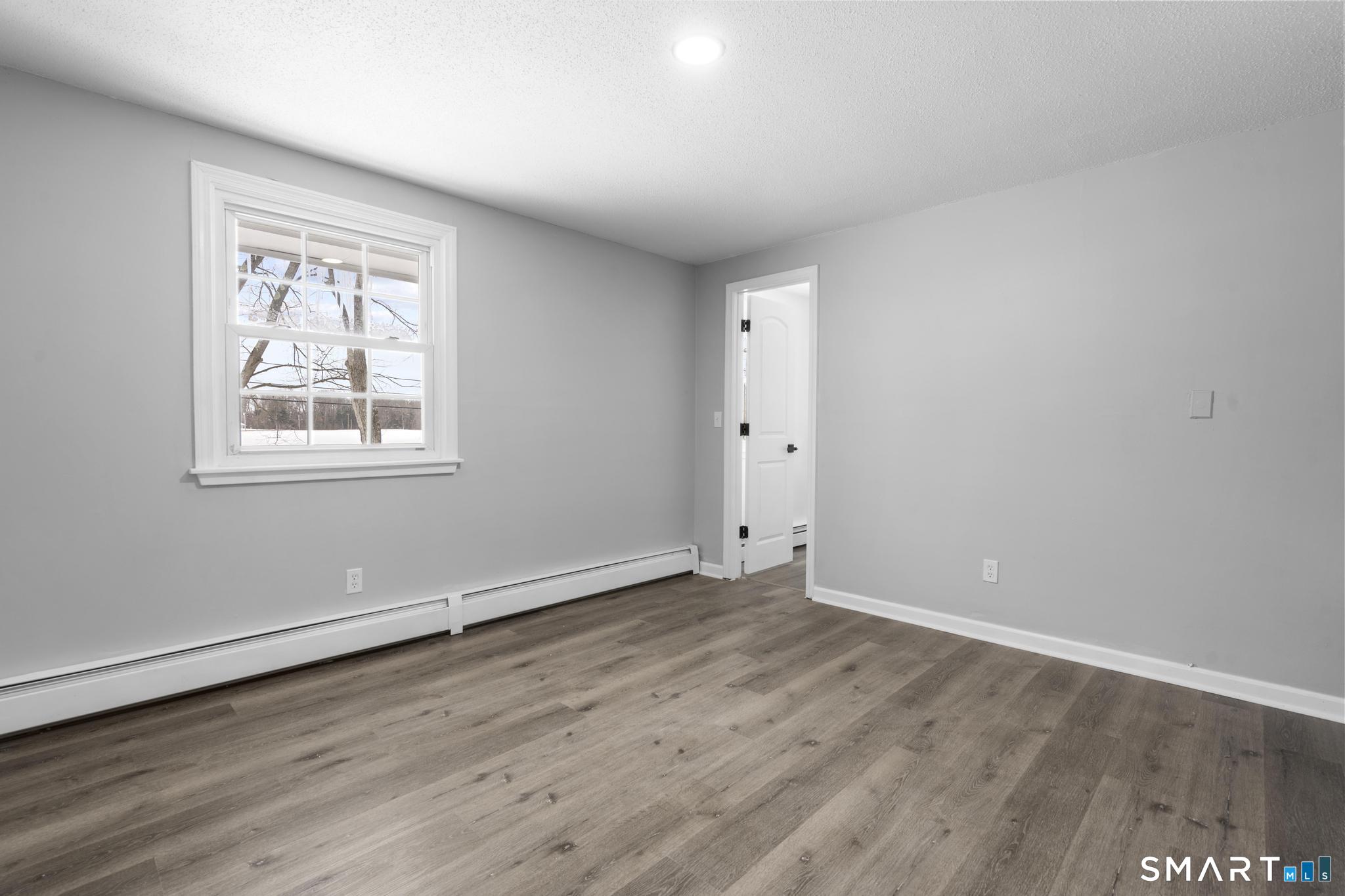 133 Phelps Road East Windsor, CT 06088 - Photo 22 of 40 an empty room with wooden floor and windows