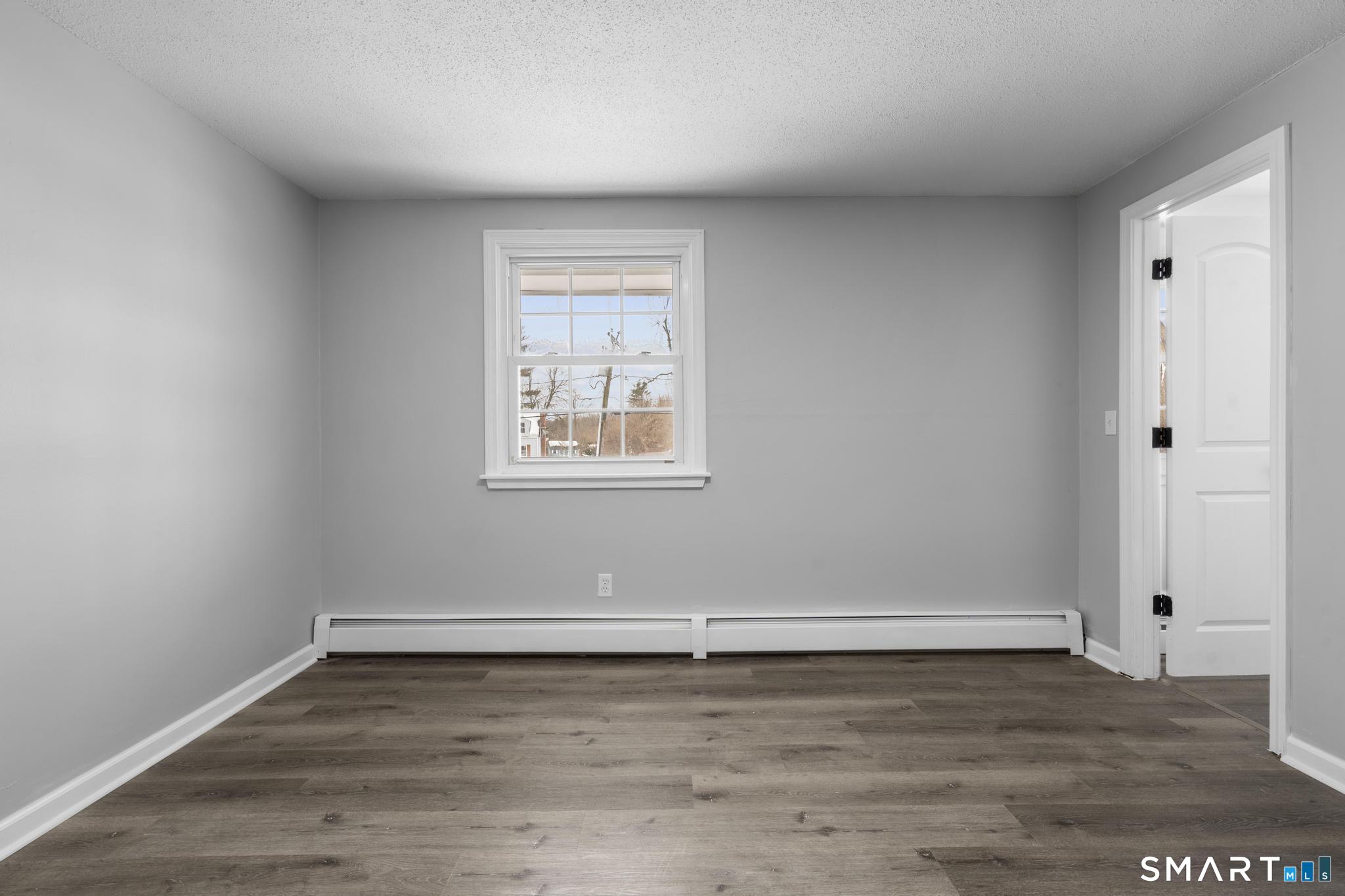 133 Phelps Road East Windsor, CT 06088 - Photo 25 of 40 an empty room with wooden floor and windows