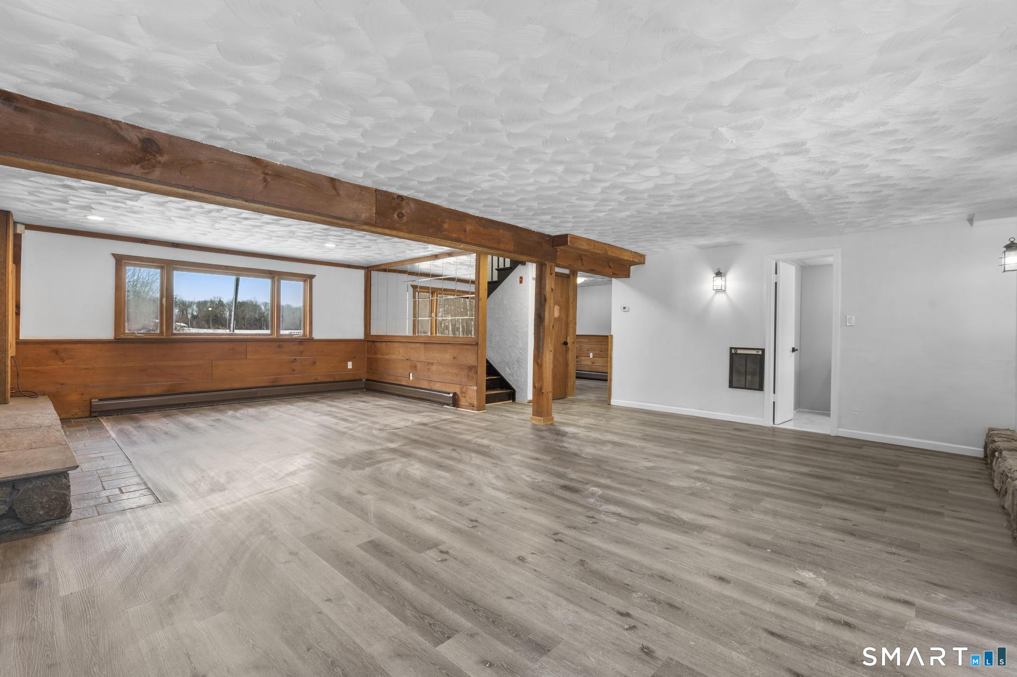 133 Phelps Road East Windsor, CT 06088 - Photo 33 of 40 a view of an empty room with wooden floor and a window