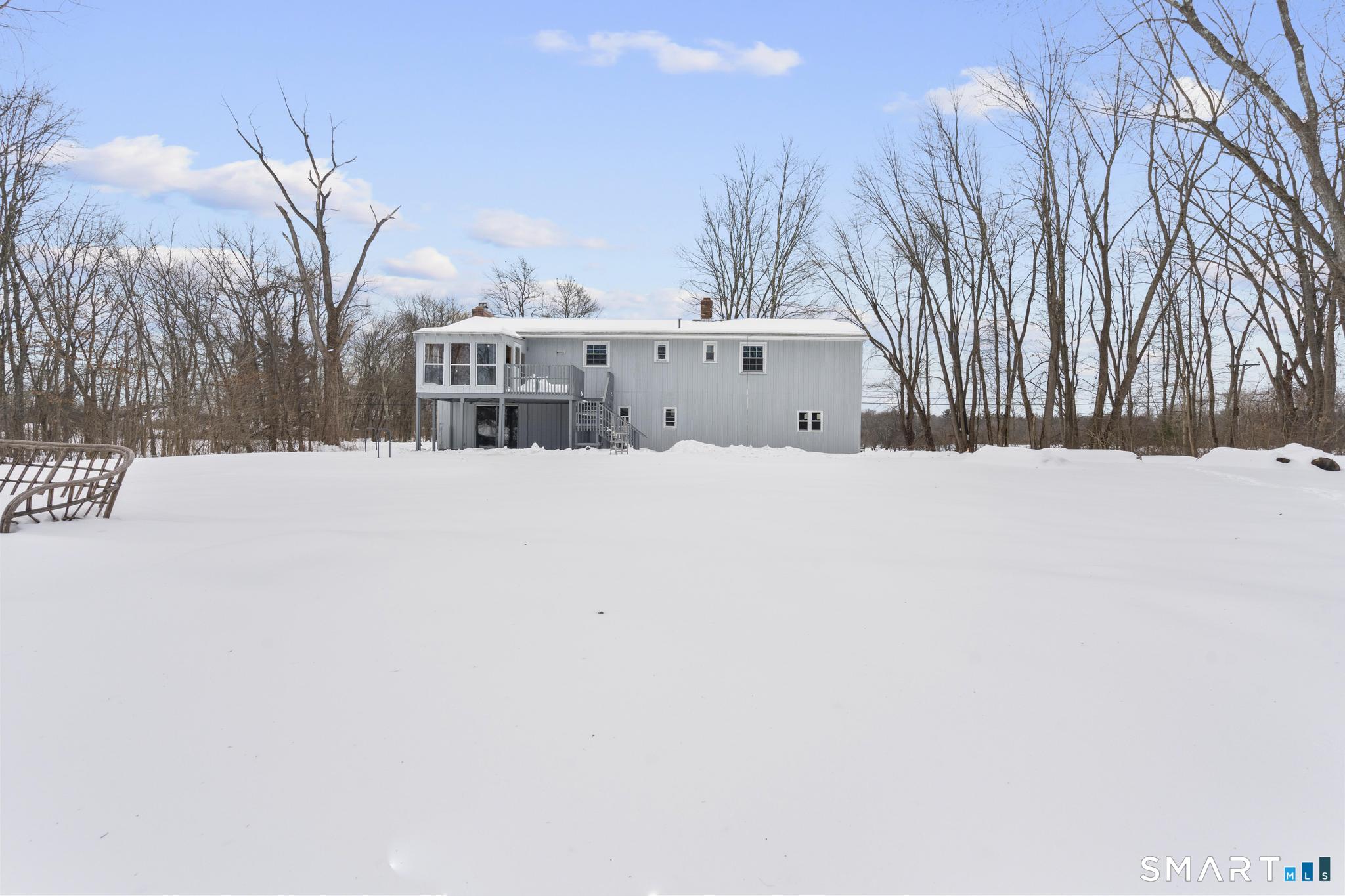 133 Phelps Road East Windsor, CT 06088 - Photo 37 of 40 a view of white house with a yard covered in snow