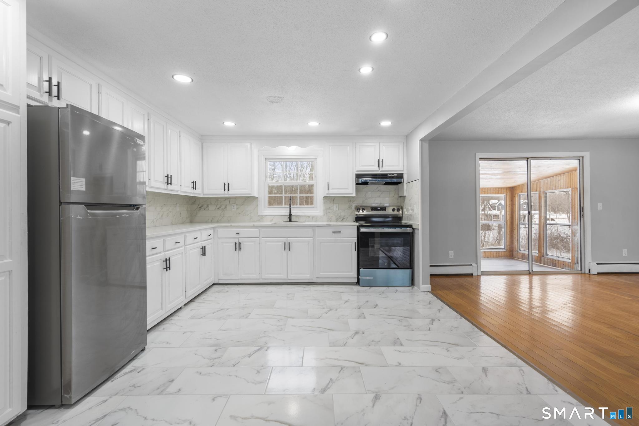133 Phelps Road East Windsor, CT 06088 - Photo 7 of 40 a kitchen with stainless steel appliances granite countertop a refrigerator sink and cabinets