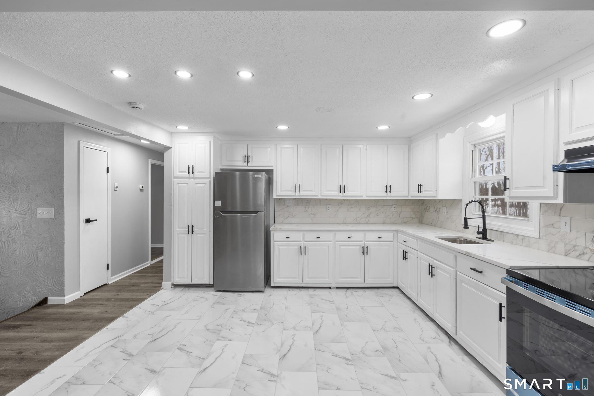 133 Phelps Road East Windsor, CT 06088 - Photo 8 of 40 a kitchen with a refrigerator and a sink