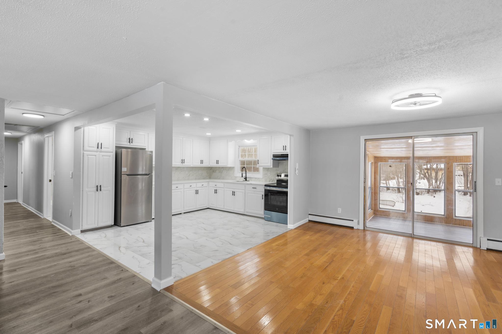 133 Phelps Road East Windsor, CT 06088 - Photo 9 of 40 a view of a kitchen with wooden floor and a sink