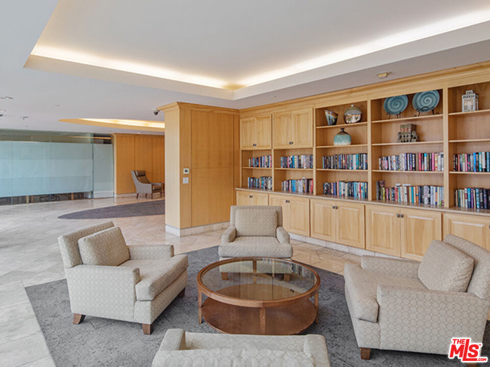 2700 Neilson Way, Unit 435 Santa Monica, CA 90405 - Photo 17 of 28 a living room with furniture and a book shelf
