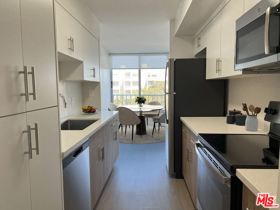 2700 Neilson Way, Unit 435 Santa Monica, CA 90405 - Photo 3 of 28 a kitchen with stainless steel appliances a sink stove and refrigerator