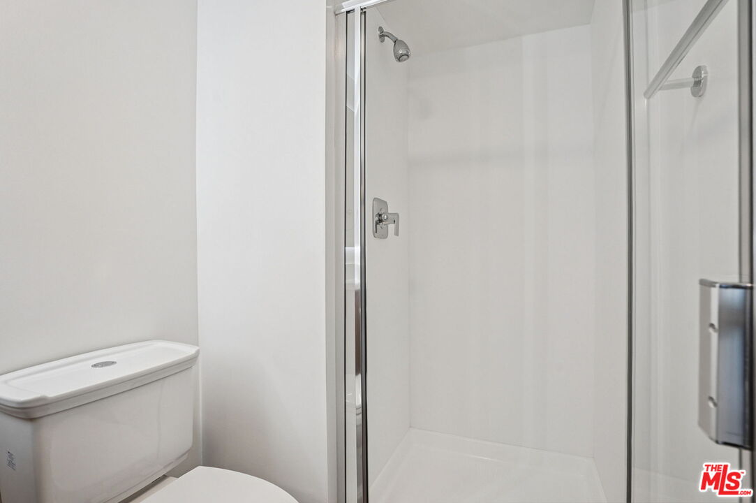 2700 Neilson Way, Unit 435 Santa Monica, CA 90405 - Photo 7 of 28 a white toilet sitting next to a shower