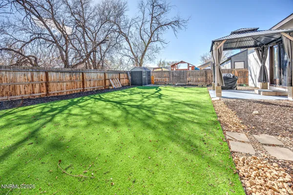 a view of a house with backyard and a garden