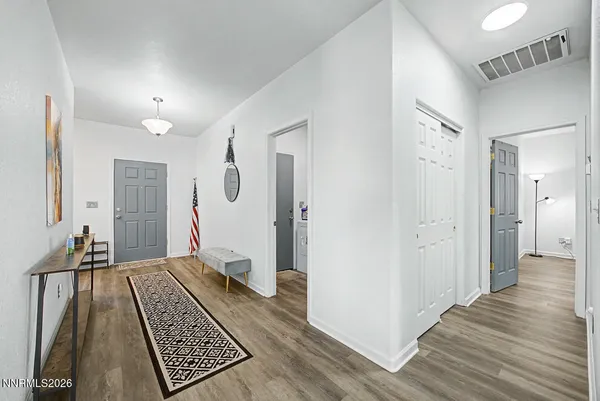 a view of a bedroom with wooden floor and a bathroom