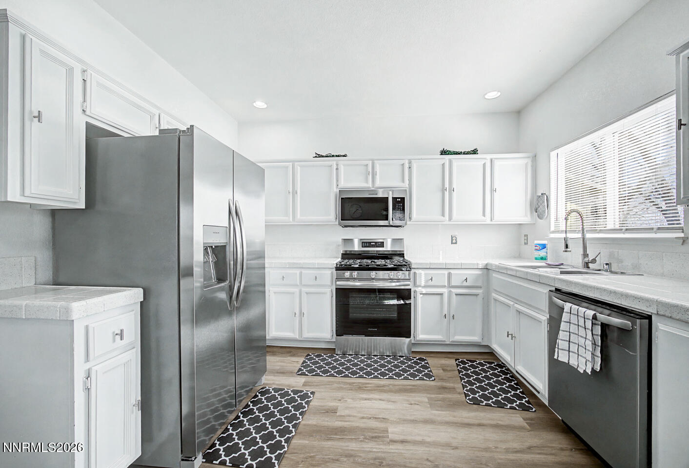 1284 Eider Circle Fallon, NV 89406 - Photo 4 of 21 a kitchen with stainless steel appliances granite countertop a refrigerator sink and stove