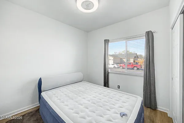 a bedroom with a bed and painting on the wall