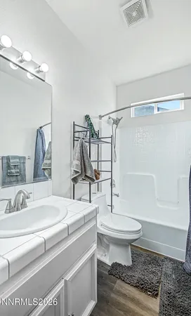 a bathroom with a sink toilet a mirror and shower