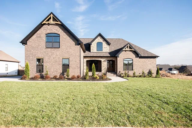 a view of a house with garden and yard