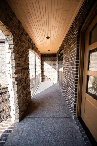 an empty room with wooden floor cabinet and windows