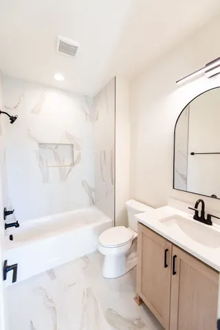 a bathroom with a glass shower door