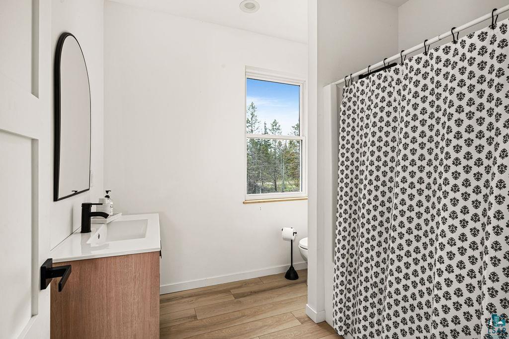 1825 East Shilhon Road Duluth, MN 55804 - Photo 33 of 37 Full bath close to 2 bedrooms featuring a window, a contemporary vanity with a white countertop, and matte black fixtures