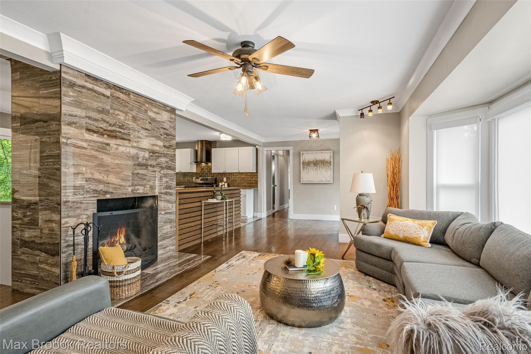 2905 Lahser Road Bloomfield Hills, MI 48304 - Photo 14 of 28 Living area featuring a stone-clad fireplace and rich wood-finish flooring