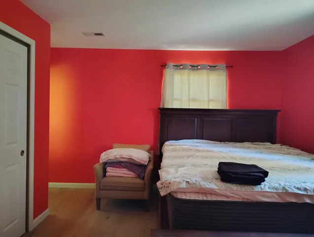 a bedroom with a bed and a flat screen tv