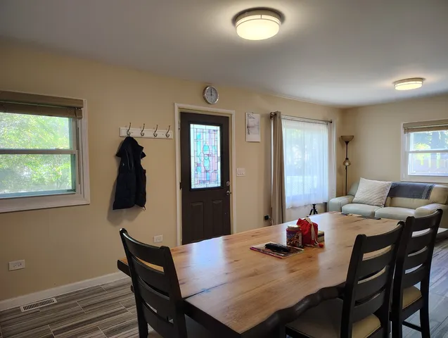 a dining room with furniture and window