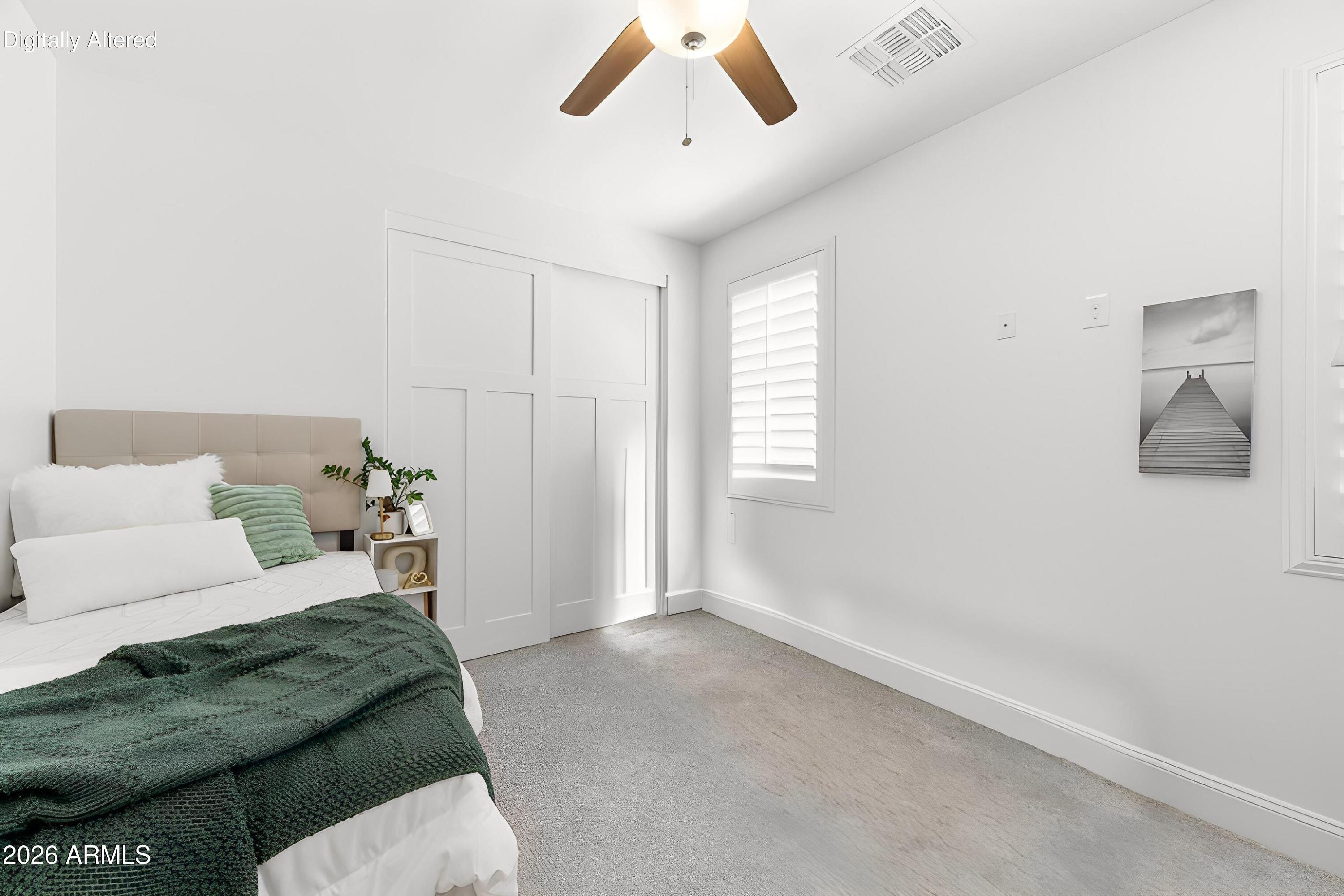 3655 East Piccadilly Road Phoenix, AZ 85018 - Photo 23 of 35 a bed room with a bed and a couch