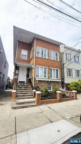 a front view of a residential apartment building with a street