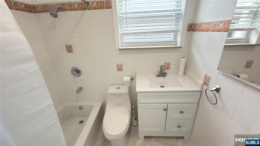 376 Delano Place, Unit 2 Fairview, NJ 07022 - Photo 11 of 21 a bathroom with a sink a toilet and shower