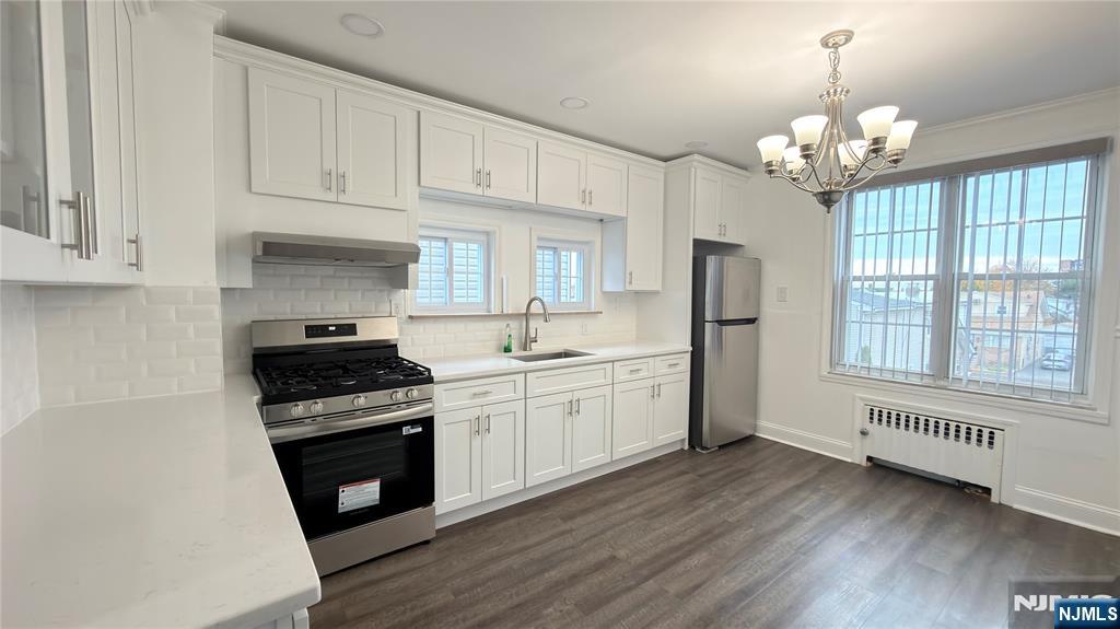 376 Delano Place, Unit 2 Fairview, NJ 07022 - Photo 18 of 21 a kitchen with stainless steel appliances granite countertop a stove a sink and a refrigerator